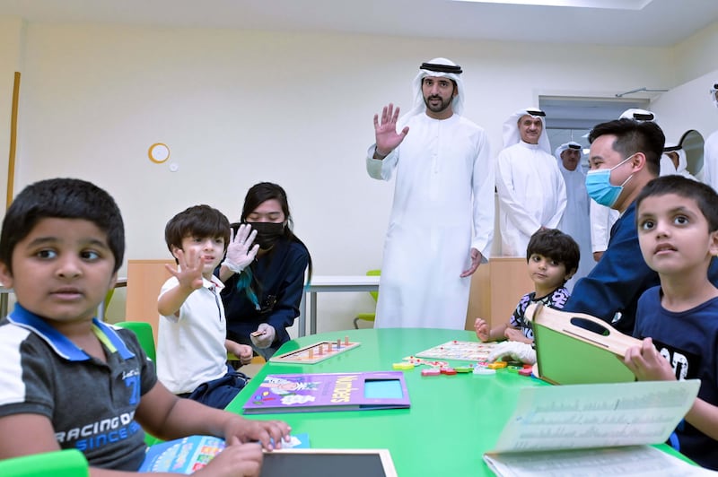 Sheikh Hamdan greets young children at the centre.