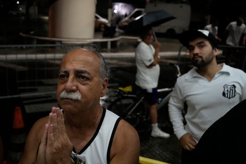 A man prays for Pele, outside the Vila Belmiro stadium, home of Santos FC. AP