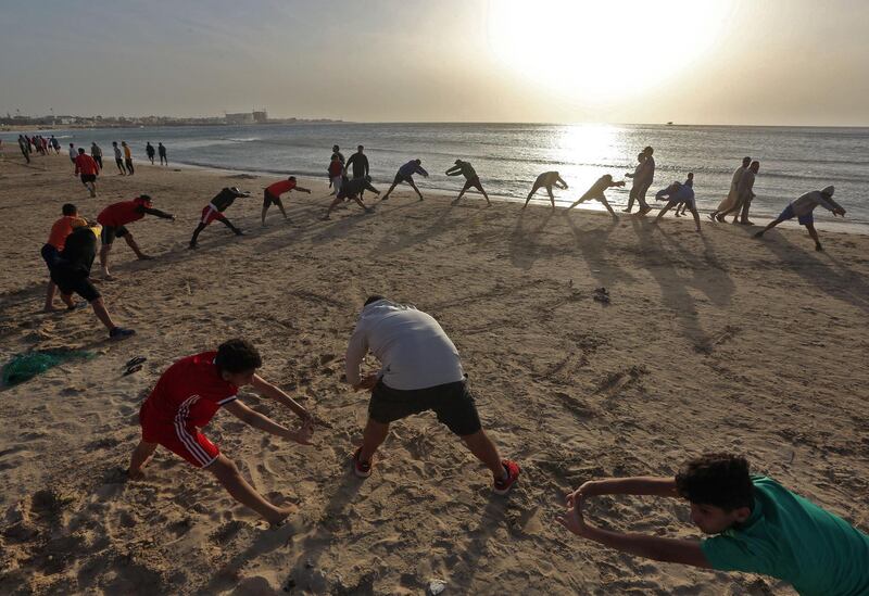 Libyans exercise at the beach before iftar, or breaking the fast, during Ramadan in the capital Tripoli. AFP