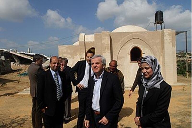 John Holmes, centre, visits an area in process of reconstruction after the Israeli offensive in Gaza, east of Jebaliya.