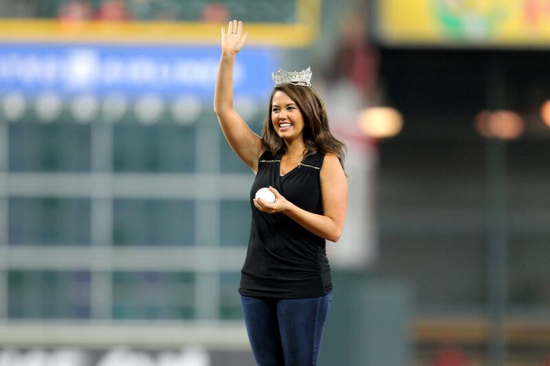 Ms Mund waves before throwing out the first pitch at a game between the Houston Astros and the Los Angeles Angels in Houston, Texas. Photo: USA Today Sports