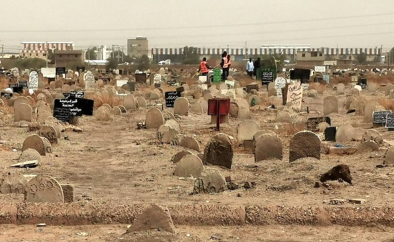 A picture taken on June 13, 2020, shows members of a forensic team at a cemetary, where a mass grave of conscripts killed in 1998 was discovered, in the Sahafa neighbourhood, south of the Sudanese capital Khartoum. Sudan's public prosecutor announced the discovery of a mass grave of conscripts killed in 1998 after trying to flee a military camp. The committee tasked with investigating the killings at Ailafoon military camp "found the mass grave in the past four days after hearing witness accounts", said public prosecutor Tagelsir al-Hebr, without giving details on the number of bodies found. / AFP / -
