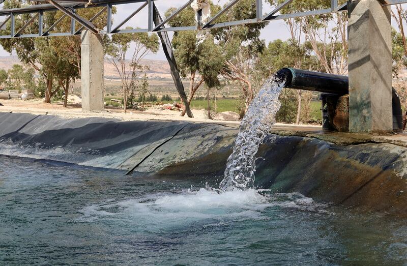 Water is pumped from a well into a pond to irrigate Hamemi agricultural farm in Kasserine, Tunisia.  Reuters