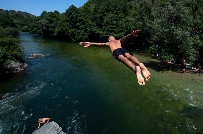Keeping cool with a jump into the River Treska on a hot day near Skopje, the capital of the Republic of North Macedonia.  A heatwave with temperatures of 41°C hit North Macedonia and its neighbours. EPA 