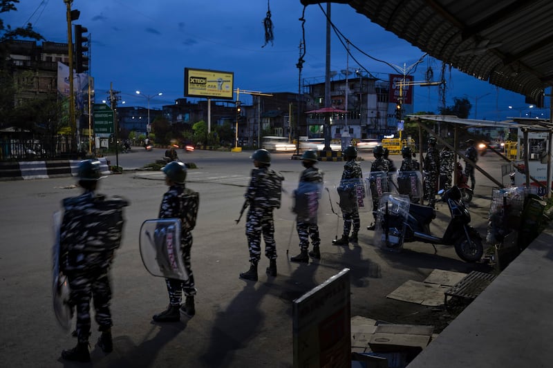 Indian paramilitary soldiers enforce a curfew in Imphal, the capital of Manipur state. AP