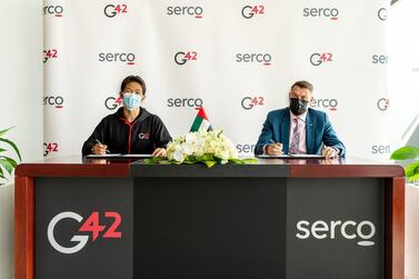G42 chief executive Peng Xiao, left, and Phil Malem, chief executive of Serco Middle East, during the signing ceremony. Courtesy Serco