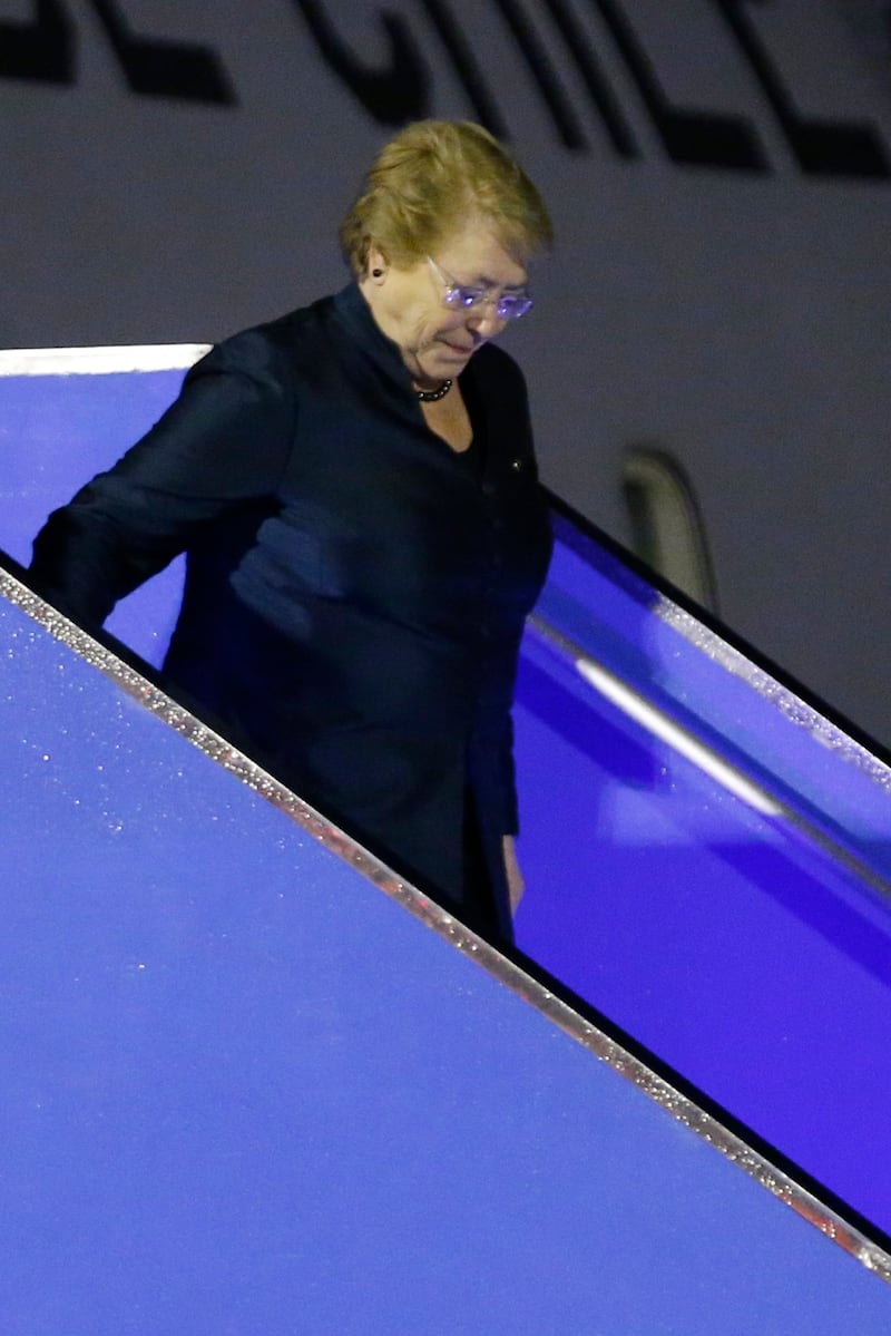 Chilean president Michelle Bachelet walks down a stairway from her plane. Wallace Woon / EPA