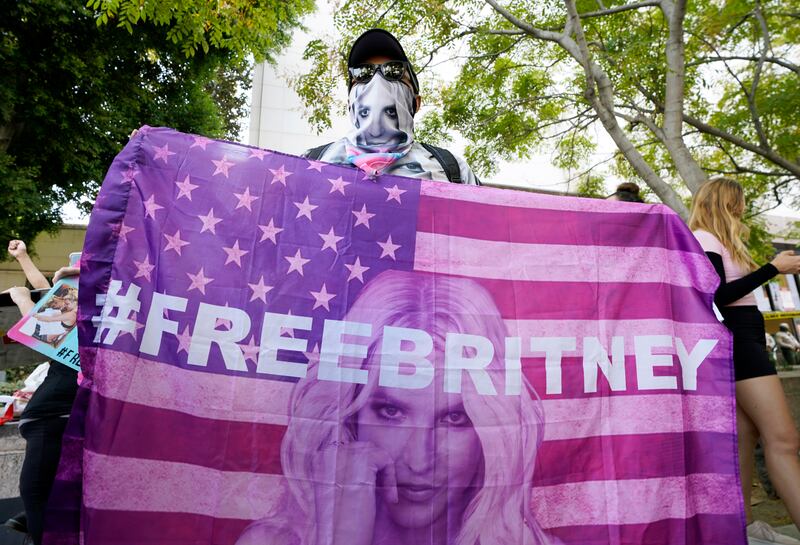 Carlos Morales of Los Angeles holds a sign featuring an American flag with an image of Britney Spears and the hashtag #FreeBritney outside the Stanley Mosk Courthouse in Los Angeles, California. AP