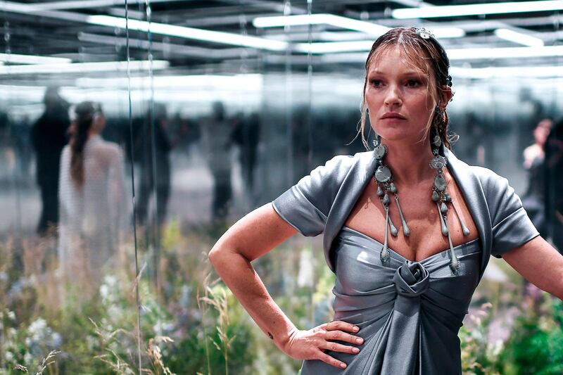 Kate Moss poses in her glass box on the Fendi runway. AFP