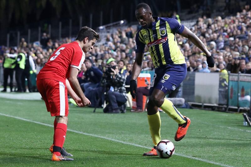 Usain Bolt on the ball during a pre-season friendly for Central Coast Mariners. AFP