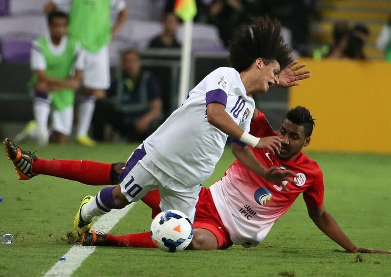 Al Ain midfielder Omar Abdulrahman is tackled by Al Jazira's Khamis Esmail during the second leg of their Asian Champions League tie on Tuesday. Karim Sahib / AFP / May 13, 2014