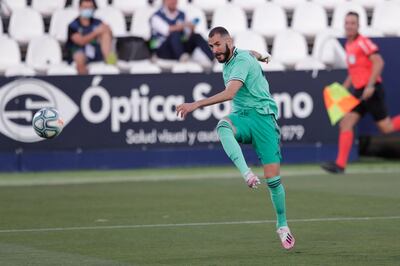 Real Madrid's Karim Benzema shoots the ball during the Spanish La Liga soccer match between Leganes and Real Madrid at the Butarque Stadium in Leganes, on the outskirts of Madrid, Spain, Sunday, July 19, 2020. (AP Photo/Bernat Armangue)