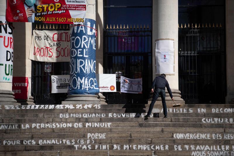 A man cleans the stairs of the occupied Theatre Graslin by culture workers, in Nantes. The workers are demanding the reopening of cultural places and theatres. AFP