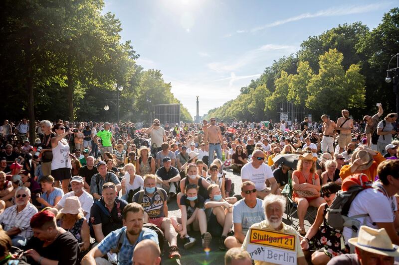 Protestors sit on the ground after the police declared the end of a protest, in Berlin, Germany. AP