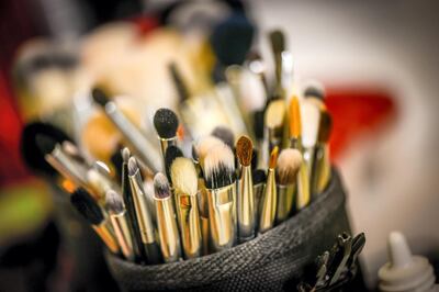 An assortment of new makeup brushes in a makeup artist's kit.