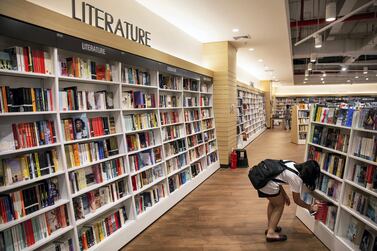 A customer picks out a book in the Kinokuniya bookshop in Phnom Penh, Cambodia. Bloomberg