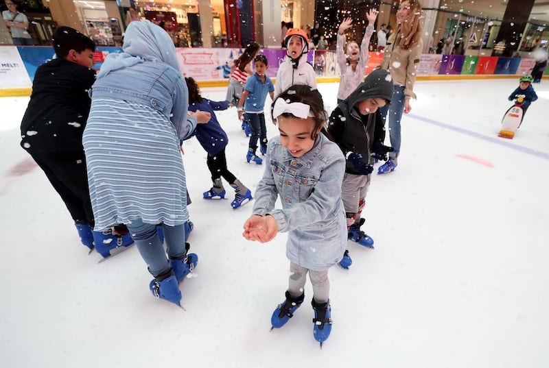 Dubai, United Arab Emirates - June 30th, 2018: Visitors ice skate with snowfall sessions. Saturday, June 30th, 2018 in Dubai Mall, Dubai. Chris Whiteoak / The National