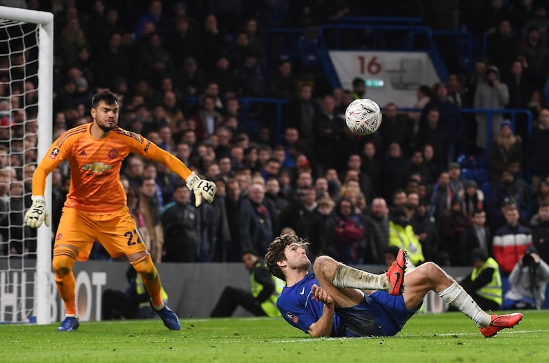 Chelsea's Marcos Alonso tries to control the ball while on the floor. EPA