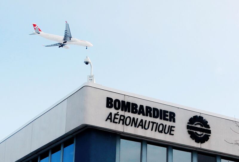 FILE PHOTO:  A plane flies over a Bombardier plant in Montreal, Quebec, Canada on January 21, 2014.   REUTERS/Christinne Muschi/File Photo