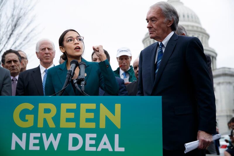 epa07351007 Democratic Representative from New York Alexandria Ocasio-Cortez (L), with US Democratic Senator from Massachusetts Ed Markey (R), delivers remarks on the 'Green New Deal' resolution during a press conference on Capitol Hill in Washington, DC, USA, 07 February 2019. The resolution emphasizes massive public investment in wind and solar production, zero-emission vehicles and high-speed rail, energy-efficient buildings, and smart power grids, as well as 'working collaboratively' with farmers and ranchers to move towards sustainable agriculture techniques.  EPA/SHAWN THEW
