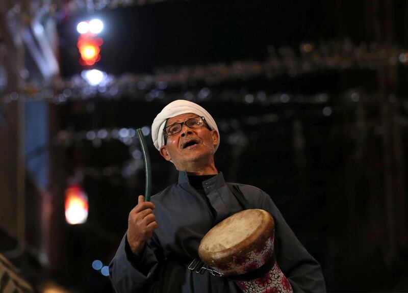 Al-Masharty Moustafa, 60, beats a drum as he wakes residents to eat their pre-dawn Suhoor meals before beginning their fasting for the day during the Muslim Holy month of Ramadan, in Cairo, as Egypt ramps up efforts to slow the spread of the coronavirus disease (COVID-19). REUTERS