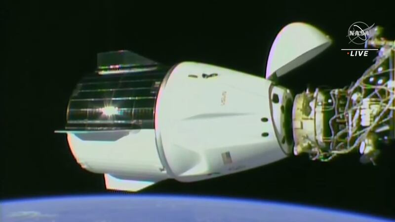 The Dragon spacecraft redocks on the space station's forward Harmony port to clear space for other spacecraft arriving later in May and in June.