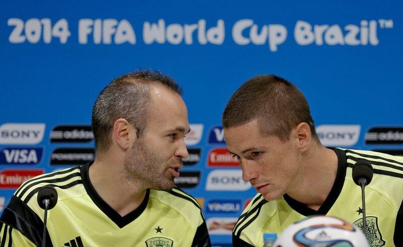 Andres Iniesta and Fernando Torres chat during a press conference on Tuesday ahead of their Wednesday match against Chile at the 2014 World Cup. Juanjo Martin / EPA / June 17, 2014