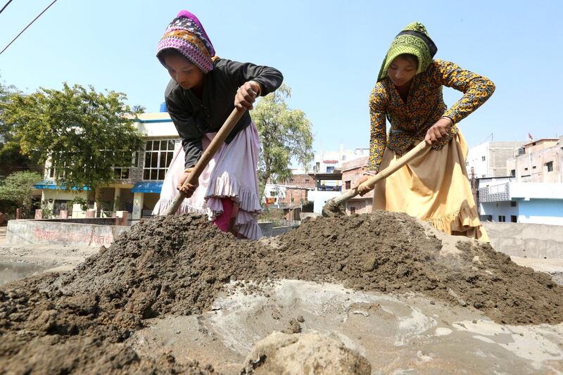 Female Indian labourers work at a construction site on the eve of International Women's Day in Bhopal, India. EPA