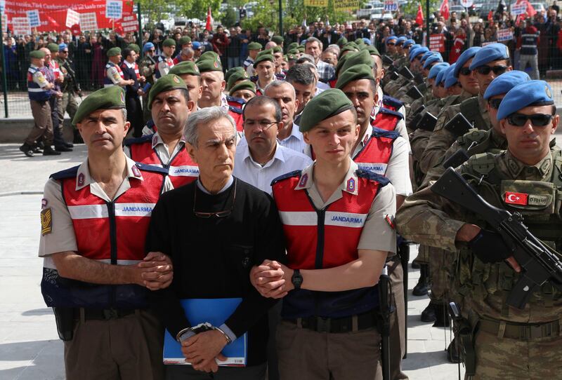 (FILES) This file photo taken on May 23, 2017 shows Turkish Gendarmerie escorting defendants Akin Ozturk (2L) and others involved in last July’s attempted coup in Turkey as they leave the prison where they are being held, ahead of their trial in Ankara.
Nearly 500 people arrested in the crackdown following the failed July 15, 2016 coup in Turkey go on trial on July 31, 2017 accused of conspiring to oust the government from an air base seen as the plotters' hub. A total of 486 suspects will go on trial in a purpose-built courtroom outside Ankara, charged with crimes ranging from murder, violating the constitution and attempting to kill President Recep Tayyip Erdogan, state-run news agency Anadolu reported. Almost all the suspects -- a total of 461 individuals -- are held in custody while seven are still on the run and the remainder charged but not in jail. Those held in custody include former air force chief Akin Ozturk who, like several suspects, is also on trial in another case related to the coup bid. / AFP PHOTO / ADEM ALTAN