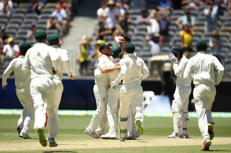 PERTH, AUSTRALIA - DECEMBER 18: Pat Cummins of Australia celebrates with team mates after taking a catch off his own bowling to dismiss Jasprit Bumrah of India and claim victory during day five of the second match in the Test series between Australia and India at Perth Stadium on December 18, 2018 in Perth, Australia. (Photo by Ryan Pierse/Getty Images)