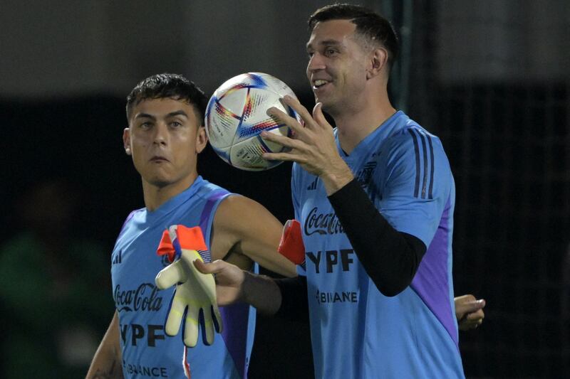 Argentina forward Paulo Dybala (L) watches goalkeeper Emiliano Martinez. AFP