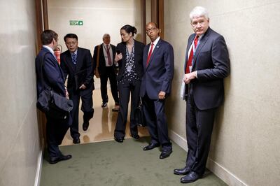 U.S. Disarmament Ambassador Robert Wood, second right, and members of delegations stand in the corridor after he left the conference in protest against Syrian presidency  at the Conference on Disarmament at the European headquarters of the United Nations in Geneva, Switzerland, Tuesday, May 29, 2018. (Salvatore Di Nolfi/Keystone via AP)