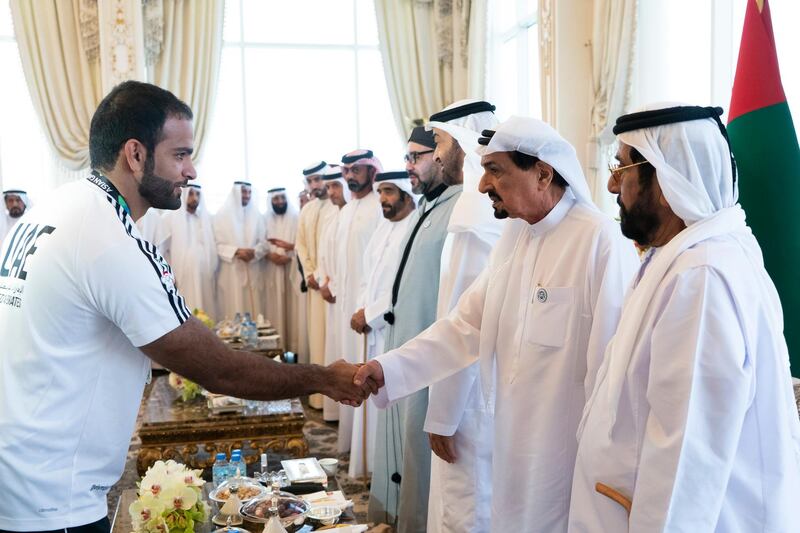 ABU DHABI, UNITED ARAB EMIRATES - September 10, 2018: HH Sheikh Humaid bin Rashid Al Nuaimi, UAE Supreme Council Member and Ruler of Ajman (2nd R), receives an 18th Asian Games Jiu Jitsu medal winner during a Sea Palace barza. Seen with HM King Mohamed VI of Morocco (4th R), HH Sheikh Mohamed bin Zayed Al Nahyan, Crown Prince of Abu Dhabi and Deputy Supreme Commander of the UAE Armed Forces (3rd R) and HH Sheikh Tahnoon bin Mohamed Al Nahyan, Ruler's Representative in Al Ain Region (R). 

(  Rashed Al Mansoori / Crown Prince Court - Abu Dhabi  )
---