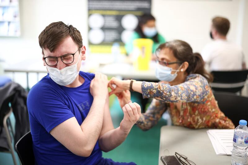 A person receives a dose of the Pfizer/BioNTech vaccine at a vaccination centre for those aged over 18 at the Belmont Health Centre in Harrow. Reuters