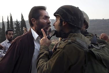 A Palestinian man argues with an Israeli soldier during clashes over an Israeli order to shut down a Palestinian school in the town of as-Sawiyah, south of Nablus in the occupied West Bank on October 15, 2018. AFP