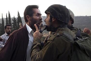 A Palestinian man argues with an Israeli soldier during clashes over an Israeli order to shut down a Palestinian school in the town of as-Sawiyah, south of Nablus in the occupied West Bank on October 15, 2018. AFP