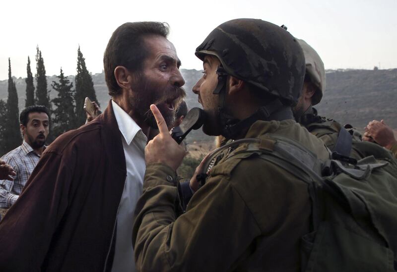 -- AFP PICTURES OF THE YEAR 2018 --

A Palestinian man argues with an Israeli soldier during clashes over an Israeli order to shut down a Palestinian school in the town of as-Sawiyah, south of Nablus in the occupied West Bank on October 15, 2018.  / AFP / JAAFAR ASHTIYEH
