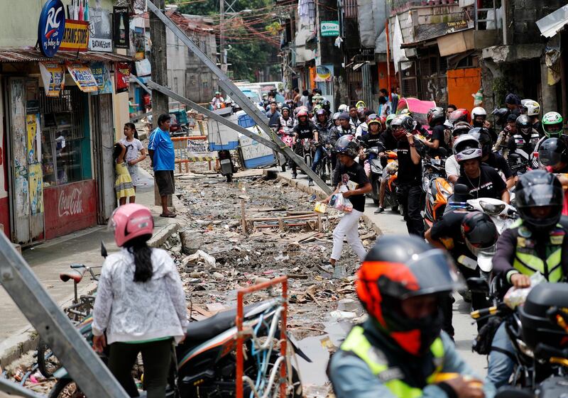 A convoy of Filipino motorcycle riders lead an aid effort in Marikina. EPA