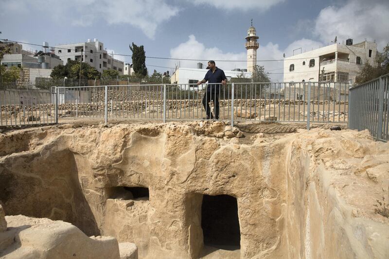 Israeli Jewish settler Haim Blycher as he looks down on  a archeological site that a sign says is a ritual bath , known in Judaism as a Mikva, located nearby the West Bank Jewish settlement of Tel Rumeida in the divided city of Hebron ."The site tells the real story by which the Jewish people were born and lived thousands of years until it was expelled," says  Blycher, a lawyer for the settlers who was active in the excavations and visited the ruins Wednesday. "Certainly, when people are exposed to the history of Hebron, it strengthens the tie of the Jewish nation and influences views among the Jewish people and the whole world.". (Photo by Heidi Levine for The National).