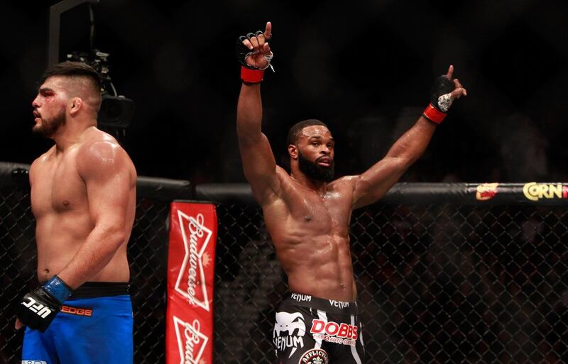 Tyron Woodley raises his arms after three rounds against Kelvin Gastelum in their welterweight bout at UFC 183 on Saturday. Woodley won the fight in a split decision. Steve Marcus / Getty Images / AFP