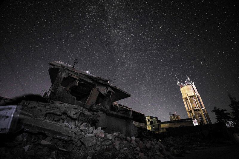 This long-exposure picture taken early on  shows a view of the Milky Way galaxy rising in the sky above the rubble of a building in the town of Binnish in the country's northwestern Idlib province.  AFP