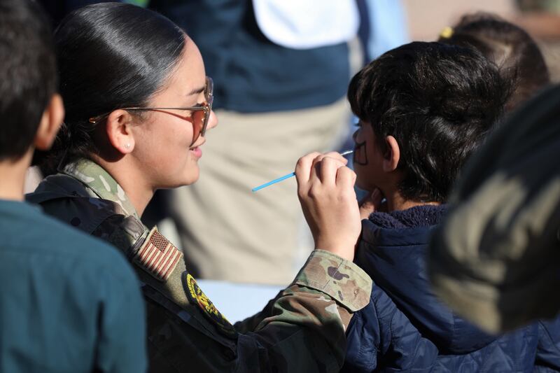 An airman assigned to Task Force Holloman paints Afghan children’s faces during the autumn safety festival at Holloman Air Force Base, New Mexico. Photo: Spc Ashleigh Maxwell / US Army