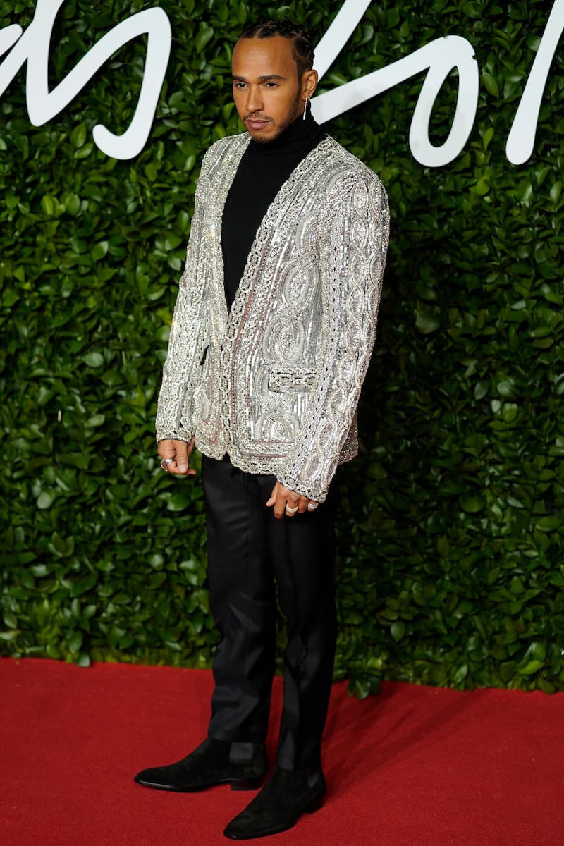 Lewis Hamilton, in a silver dinner jacket, arrives for The Fashion Awards at the Royal Albert Hall on December 2, 2019. EPA