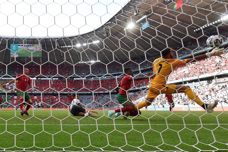 Germany's players celebrate their first goal, an own goal by Portugal's defender Ruben Dias. AFP