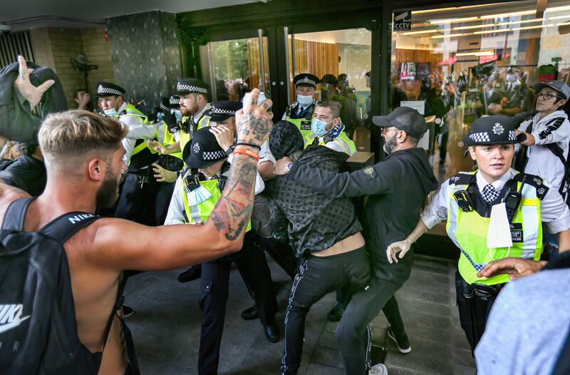 Police officers stop protesters from entering the BBC Studioworks building in London, during a demonstration against Covid-19 restrictions in August. Getty Images