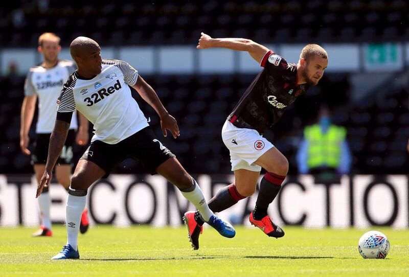 Readingâ€™s George Puscas (right) and Derby County's Andre Wisdom battle for the ball during the Sky Bet Championship match at Pride Park, Derby. PA Photo. Issue date: Saturday June 27, 2020. See PA story SOCCER Derby. Photo credit should read: Mike Egerton/PA Wire. RESTRICTIONS: EDITORIAL USE ONLY No use with unauthorised audio, video, data, fixture lists, club/league logos or "live" services. Online in-match use limited to 120 images, no video emulation. No use in betting, games or single club/league/player publications.