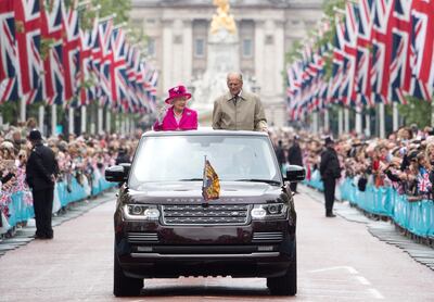 LONDON, ENGLAND - JUNE 12: Queen Elizabeth II and Prince Philip, Duke of Edinburgh wave to guests attending "The Patron's Lunch" celebrations for The Queen's 90th birthday on The Mall on June 12, 2016 in London, England. 10,000 guests have gathered on The Mall for a lunch to celebrate The Queen's Patronage of more than 600 charities and organisations. The lunch is part of a weekend of celebrations marking Queen Elizabeth II's 90th birthday and 63 year reign. The Duke of Edinburgh and other members of The Royal Family are also in attendance. During the lunch a carnival parade will travel down The Mall and around St James's Park.  (Photo by Arthur Edwards - WPA Pool/Getty Images)