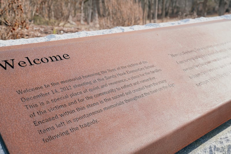 A plaque welcomes visitors to the Sandy Hook Memorial. Inside the stone block are the incinerated remains of teddy bears, photos, flowers and letters that make up the 'sacred soil' of the memorial. Reuters
