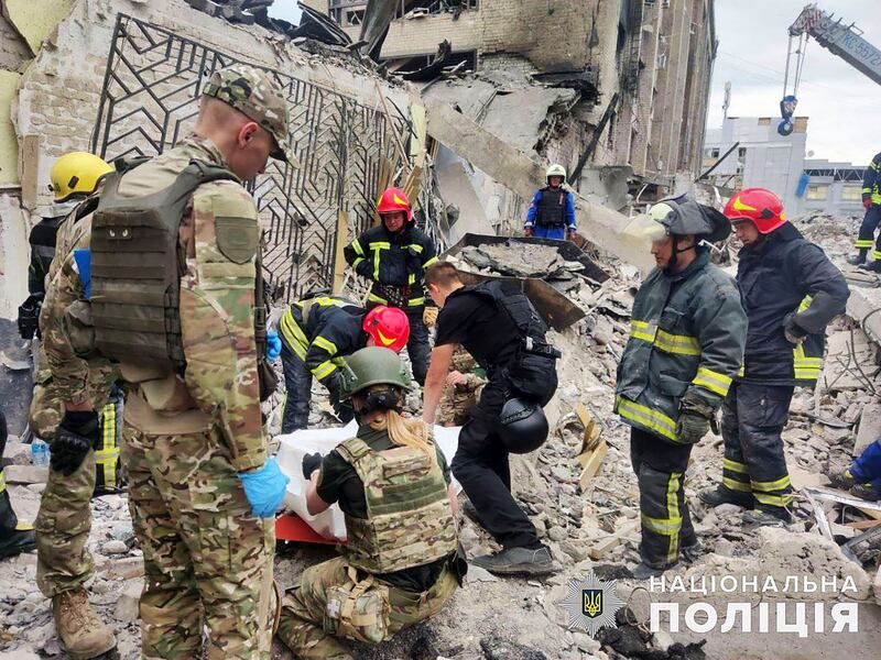 Rescuers at work at the site of a rocket strike in downtown Kramatorsk. EPA