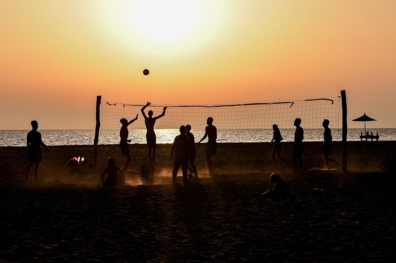 Beachgoers play volleyball at sunset near coastal town of Shengjin, Albania. AFP